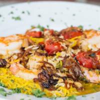 Capellini Alexandra · Jumbo shrimp, crab, roasted red peppers and caramelized onions in a white wine pesto. Served...