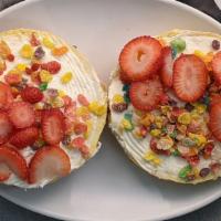 Fruity Pebbles Overflow · Fruity Pebbles bagel with vanilla milkshake cream cheese and fresh strawberries in the middle