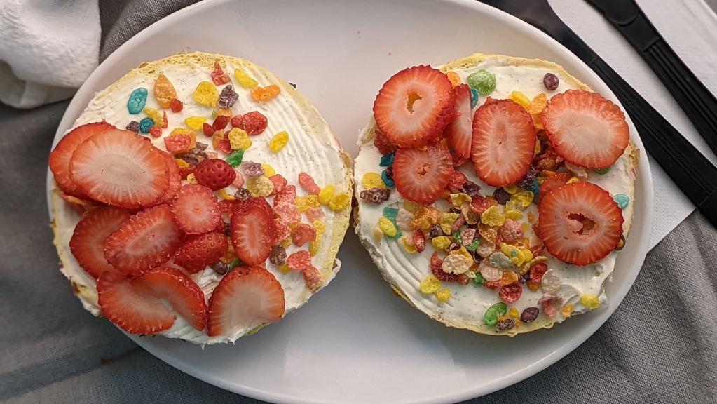 Fruity Pebbles Overflow · Fruity Pebbles bagel with vanilla milkshake cream cheese and fresh strawberries in the middle