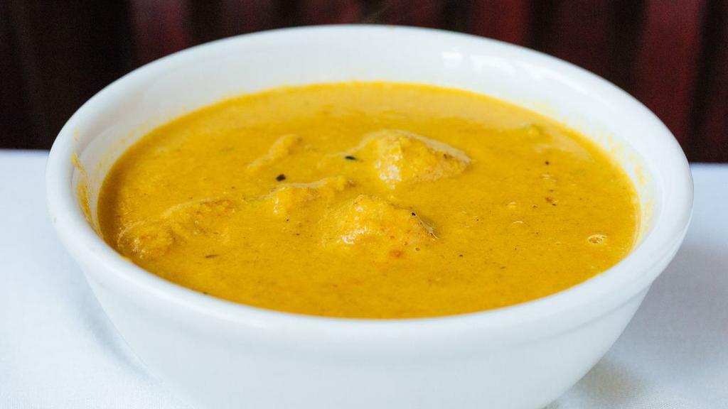 Chicken Shahi Korma · A Moghulai delight! Cardamoms flavored sweet and spicy curried chicken in cream , cashews, and raisins.