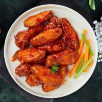 Buffalo Chicken Wings · Wings cooked and tossed in our buffalo wing sauce. Served with Blue Cheese.