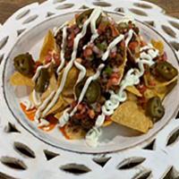 Nachos (Meat+Jalapenos+Pico+Sour Cream) · Corn Tortilla chips with queso +  protein of your choice + jalapenos + pico de galo + sour c...
