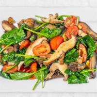Wild Mushroom Sauté · Shiitakes, oysters and portabellas sautéed in oil and garlic with fresh spinach and tomatoes.