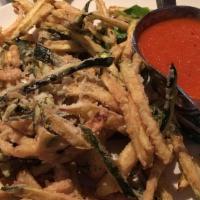 Zucchini Fritti · Fresh julienned strips of zucchini, flour-dipped and lightly battered, served with a marinar...
