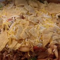 Beef Taco Salad · Ground beef over onions, peppers, salsa, taco seasoning and taco chips, romaine and mozzarel...