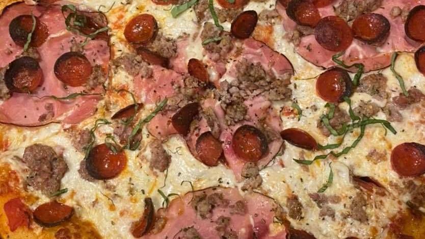 The Exorcist · Black forest smoked ham, roasted mushrooms, olives, oregano, pecorino, freshly grated mozzarella, crushed tomatoes. Large pizza.