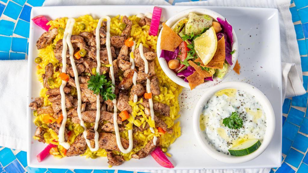 Kabsi Rice Platter · Rice with veggies topped with your choice of meat (Topped with garlic sauce.) 
 and and two sides:  (Topped with garlic sauce.)
 Tzatziki dip & Marlena's salad