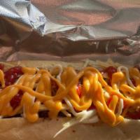 Dominican Hot Dog · Topped with ground beef, Cabbage, Melted Cheese, Mayo, Ketchup, Mustard and Chips.