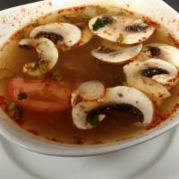 Tom Yum Koong · Spicy. A special thai style milky hot & sour soup with chili, tomatoes, scallion and pieces ...