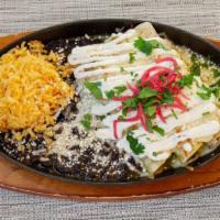 Pollo Enchiladas · Yellow Rice, Black Beans, Sour Cream, Queso Fresco, Onions, Mole Verde