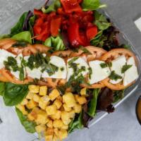 Caprese Salad · Spring mix, tomatoes, fresh mozzarella, red roasted pepper, crotons seasoned with extra virg...