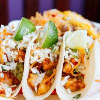 Chipotle Shrimp Tacos · Three corn tortillas, sautéed chipotle marinated shrimp, guacamole, zesty slaw, and tomatill...