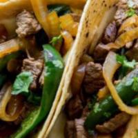 Steak Tacos · Three corn tortillas, grilled sirloin steak and onions, chopped cilantro, lime, roasted toma...