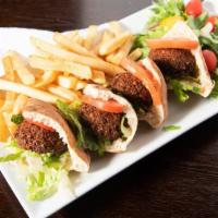 Falafel Sandwich · Fresh home-made falafel in pita served with lettuce, tomato, cucumber, and tahini sauce.