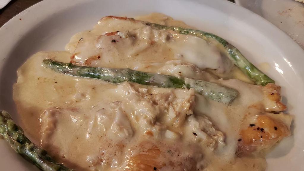 Chicken Alaska · Breast of chicken topped with crabmeat, asparagus & mozzarella in a cream sauce.