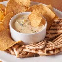 Warm Spinach And Artichoke Dip · Served with a plate of warm nacho chips and warmed flatbread.