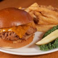 Pulled Pork Sandwich · Slow-roasted, hand-pulled pork smothered in our own BBQ sauce, topped with melted cheddar ch...