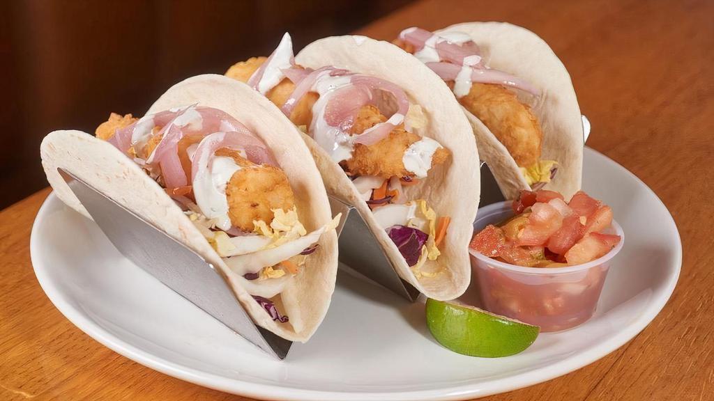 Fish Tacos · Fried haddock over a Napa cabbage slaw with pico de gallo, pickled onion and cilantro creme served in three warm corn or flour tortillas. Also served with Mexican rice.