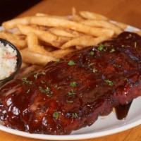 1/2 Rack Bbq Baby Back Ribs · 1/2 rack of our slow roasted Hickory BBQ Pork Ribs served with homemade coleslaw and french ...