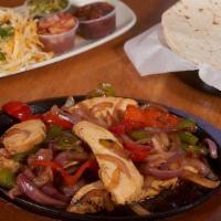 Fajita'S ~ Gluten Free · Grilled strips of marinated steak, chicken, or shrimp, served sizzling hot with bell peppers...