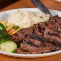 Steak Tips ~ Gluten Free · Hand-cut marinated sirloin tips served over caramelized onions with our fresh steamed vegeta...