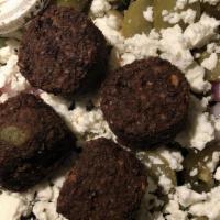 Falafel · Fried patties made of crushed chickpeas mixed with herbs and spices.