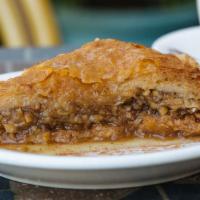 Baklava · Layers of fillo dough, stuffed walnuts and topped with honey syrup.