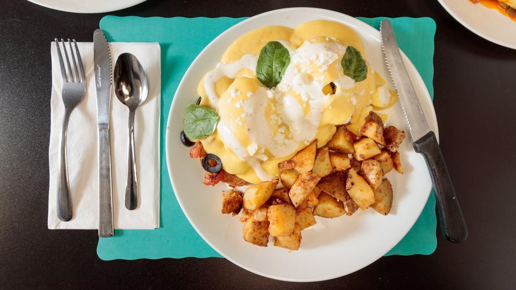 Greek Style Eggs Benedict  · Two poached eggs served over Canadian bacon, spinach, feta cheese, tomatoes, black olive, English muffin, and topped with hollandaise and greek sauce. Served with home fries and toast.