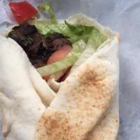 Kafta Roll · Wrapped in pita bread served with lettuce, tomatoes, onions, and dressing.