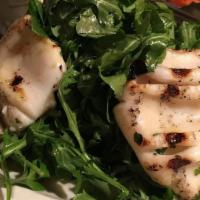 Grilled Calamari · over arugula salad with a vinaigrette dressing.