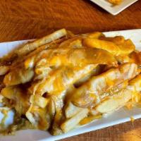 Curry Cheese Fries · A heaping pile of French fries generously topped with melted cheddar cheese and our Irish cu...