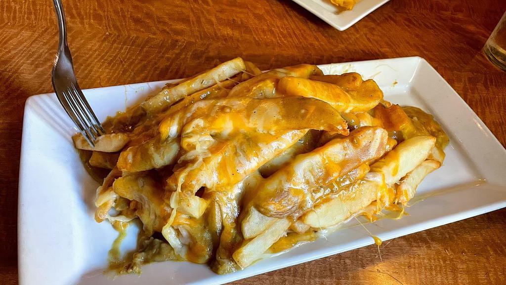 Curry Cheese Fries · A heaping pile of French fries generously topped with melted cheddar cheese and our Irish curry sauce.