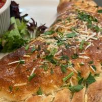 Veggie Calzone · Onion, peppers, spinach, mushrooms, tomatoes, mozzarella and ricotta.