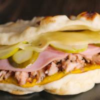 Cubano · Slow-roasted pork, cheese, ham, pickles and mustard