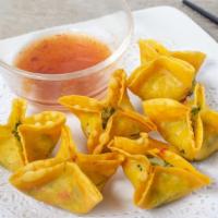 Crab Rangoon · Homemade wonton filled with cream cheese, crabmeat, chopped onion and served with pineapple ...