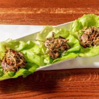 Duck Lettuce Cups · Pan seared duck breast over Boston lettuce with hoisin glaze and fried leeks.