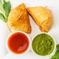 Veg Samosa (2 Pcs) · A crispy pastry stuffed with potatoes, peas and spices served with tamarind and mint chutney.