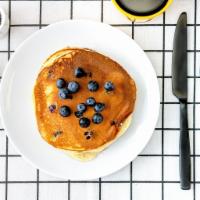 Labs Blueberry Pancakes · Two fluffy pancakes with blueberries served with a side of butter and syrup. Stack.It.Up.