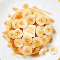 Labc Banana Pancakes · Two fluffy pancakes with bananas served with a side of butter and syrup. Rise and shine.