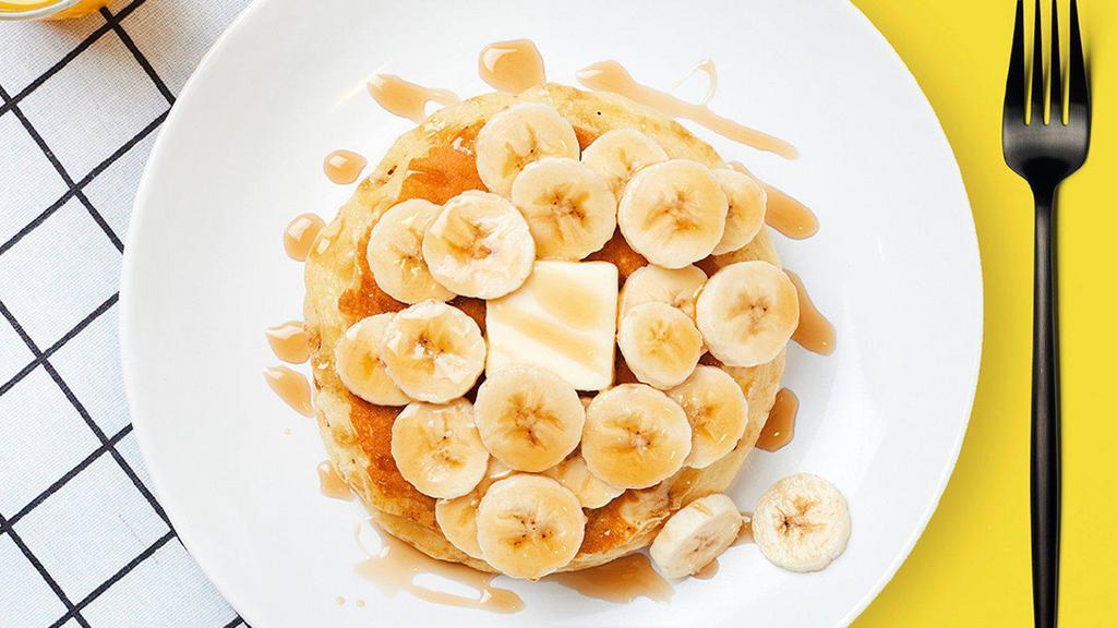 Labc Banana Pancakes · Two fluffy pancakes with bananas served with a side of butter and syrup. Rise and shine.