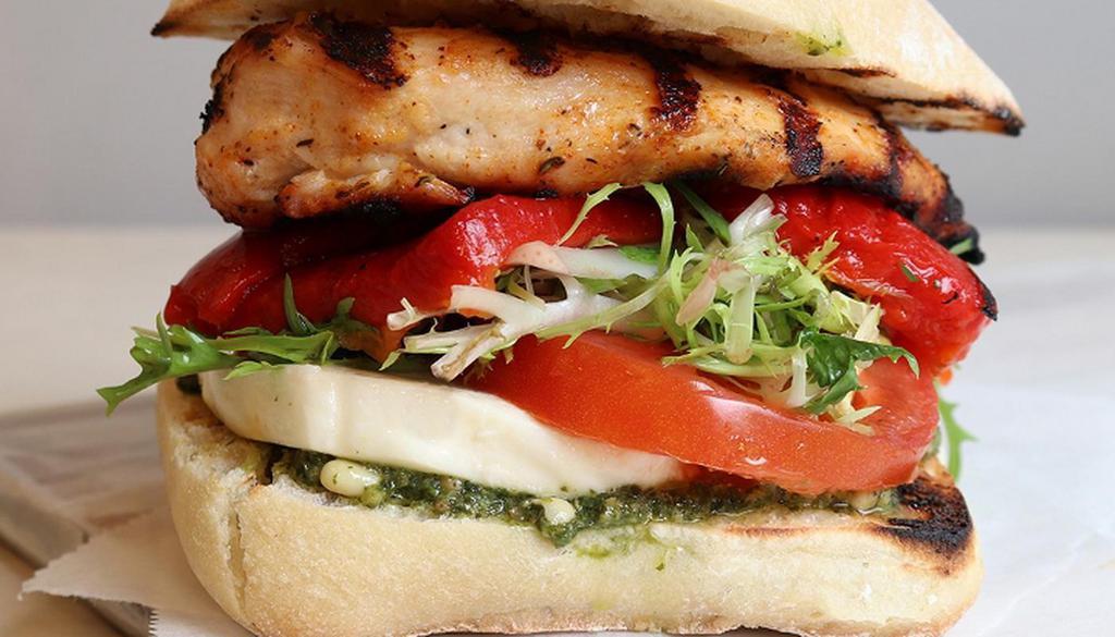 Grilled Chicken Pesto · chicken, mozzarella, roasted red pepper, tomato, frisee, pine nut pesto, on toasted ciabatta (cal: 840) - Allergens: Dairy, Nut, Wheat