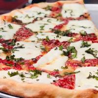 Margarita Pizza · Thin crust, marinara, garlic, basil and fresh mozzarella.
