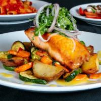Citrus Salmon · Pan seared salmon in a gran marnier citrus sauce, served with chefs potato and mixed arugule...