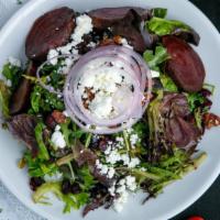 Roasted Beet Salad · Mixed greens and arugula served with candied pecans, red onions, roasted beets. made raisins...