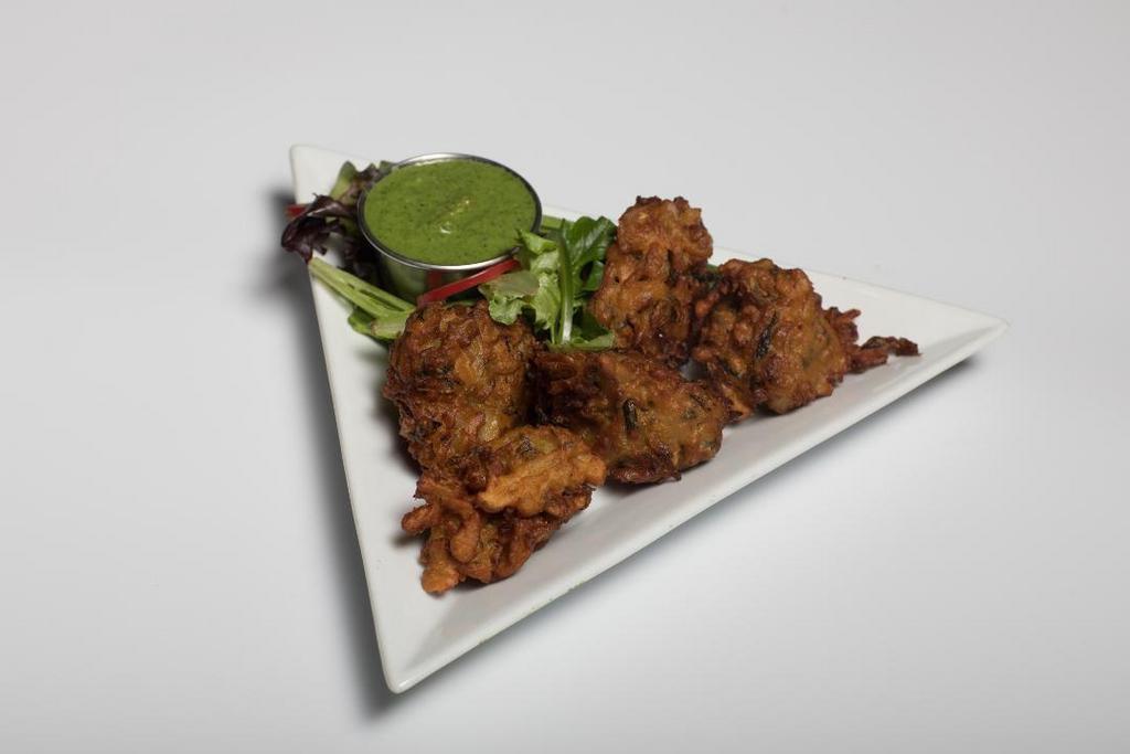 Vegetable Pakoras · Cut vegetable fritters deep fried in chickpea batter. Served with homemade chutneys.