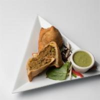 Lamb Samosas · Deep fried light spicy turnovers stuffed with minced lamb and green peas. Served  with homem...
