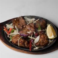 Lamb Tikka · Boneless lamb leg cubed and marinated in yogurt and an array of spices, cooked in our tandoo...