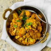 Aloo Gobhi · Potatoes and cauliflower sauteed with onion, ginger, garlic, and aromatic spices. Served wit...