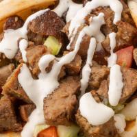 Lamb Gyro · Lamb on pita bread lettuce tomatoes onions home made hot sauce and white sauce