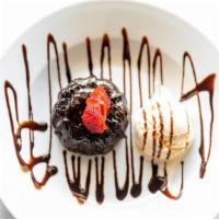 Chocolate Lava Cake (Petit Gâteau) · Molten cake topped with vanilla ice cream and chocolate syrup.